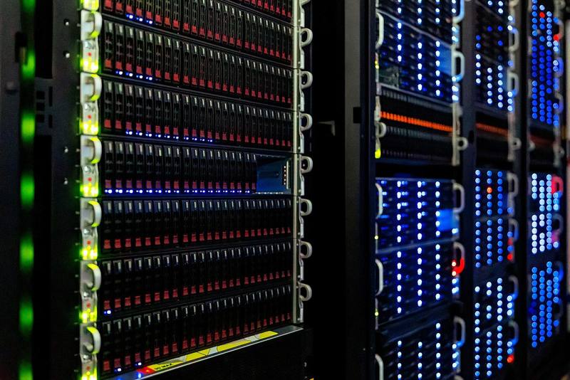 Close-up of server racks with rows of blue and red indicator lights