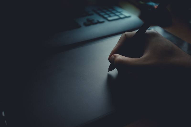 Hand drawing with a stylus on a graphics tablet in low light