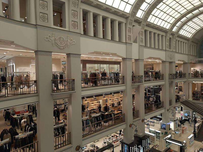 Galleried atrium of a department store under a vaulted glass roof
