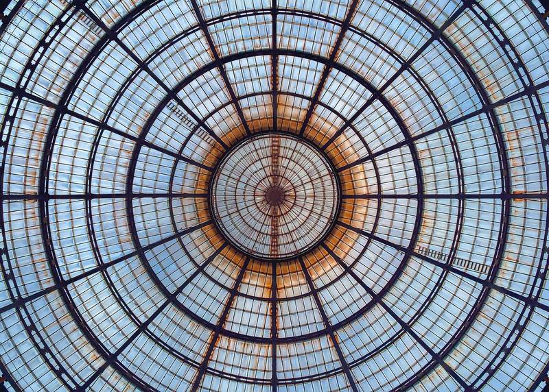 Looking up into an iron and glass dome with radiating ribs
